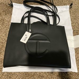 Medium Black Teflar Bag. BRAND NEW. NEVER WORN. Dust bag included.